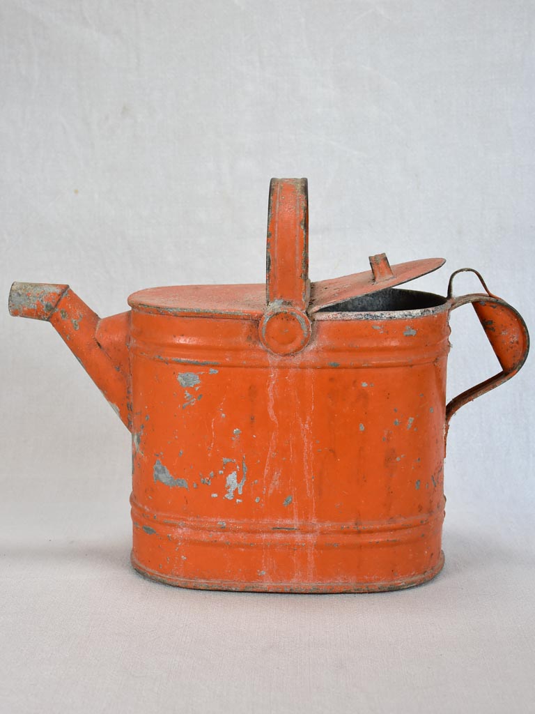 Antique French covered watering can with red patina
