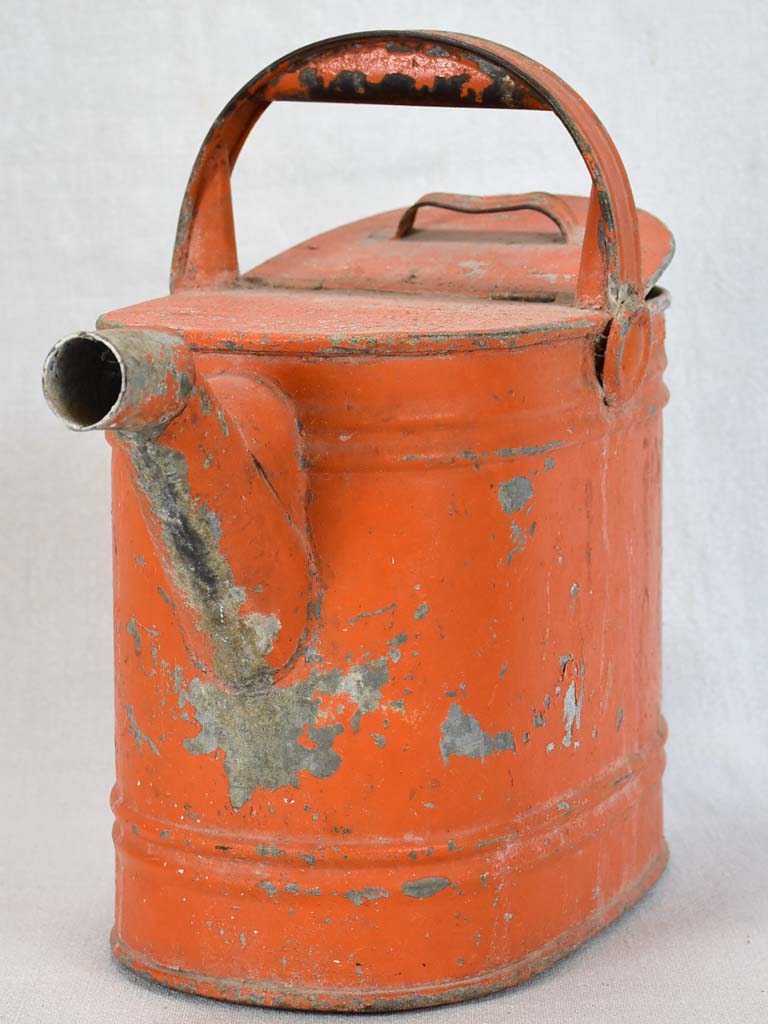 Antique French covered watering can with red patina