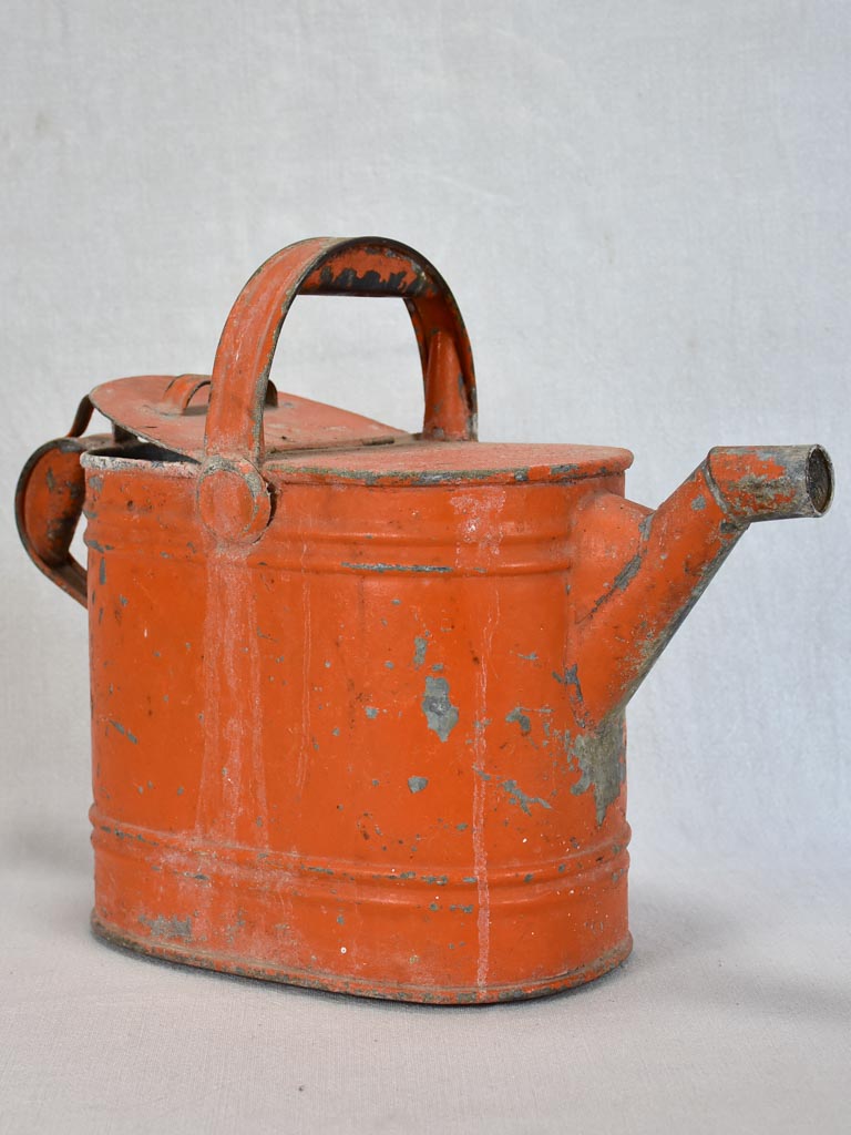 Antique French covered watering can with red patina