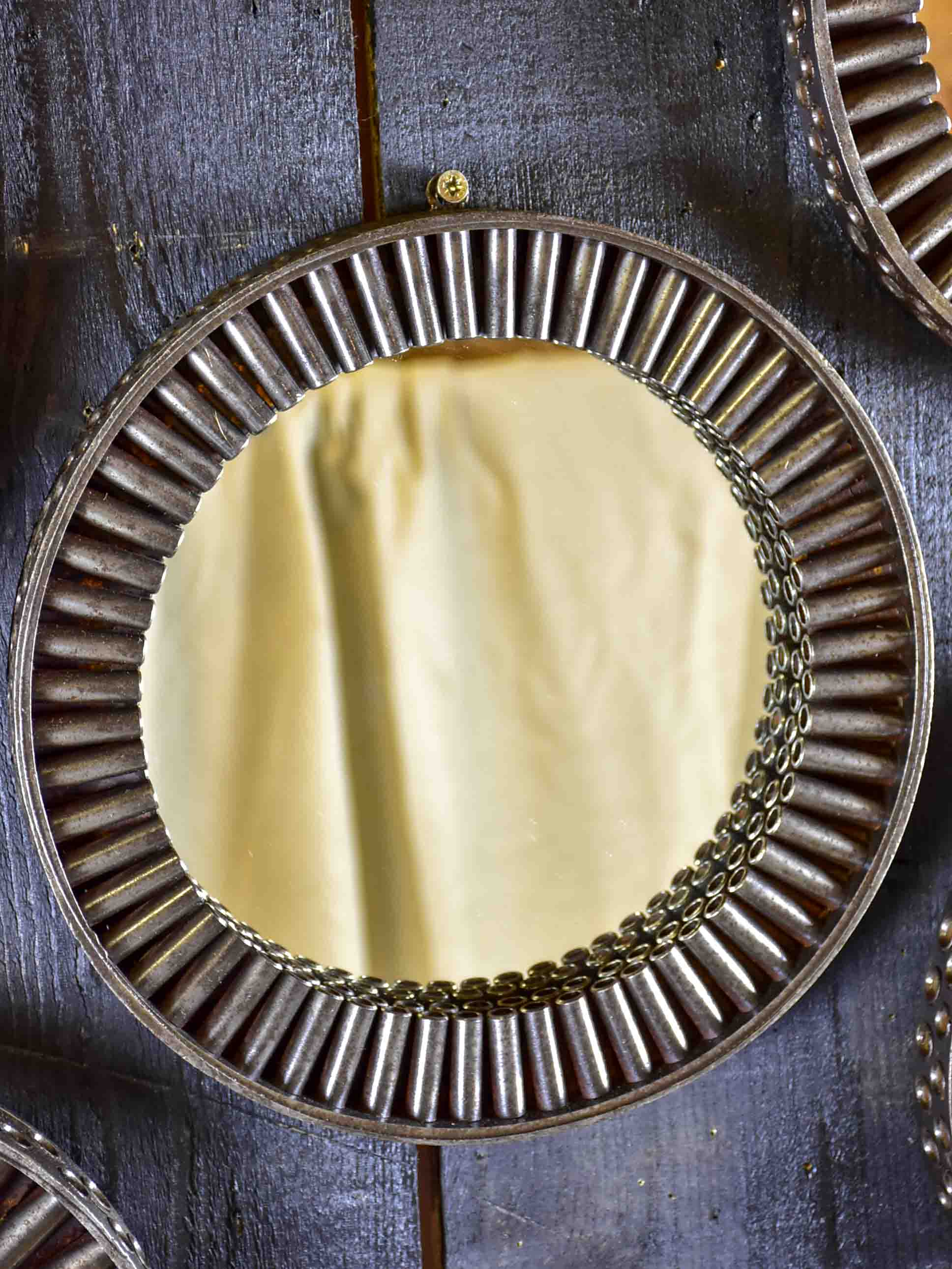 Round mirrors made from salvaged industrial materials