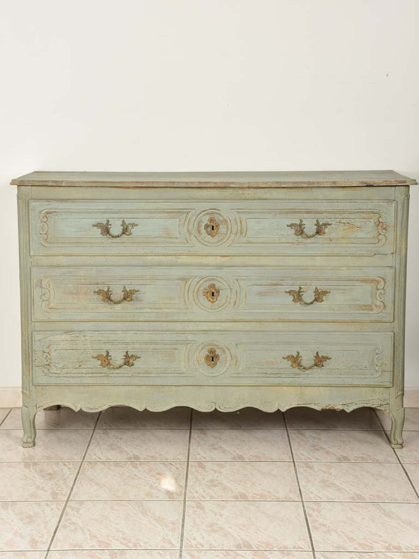 Aged wooden three-drawer commode