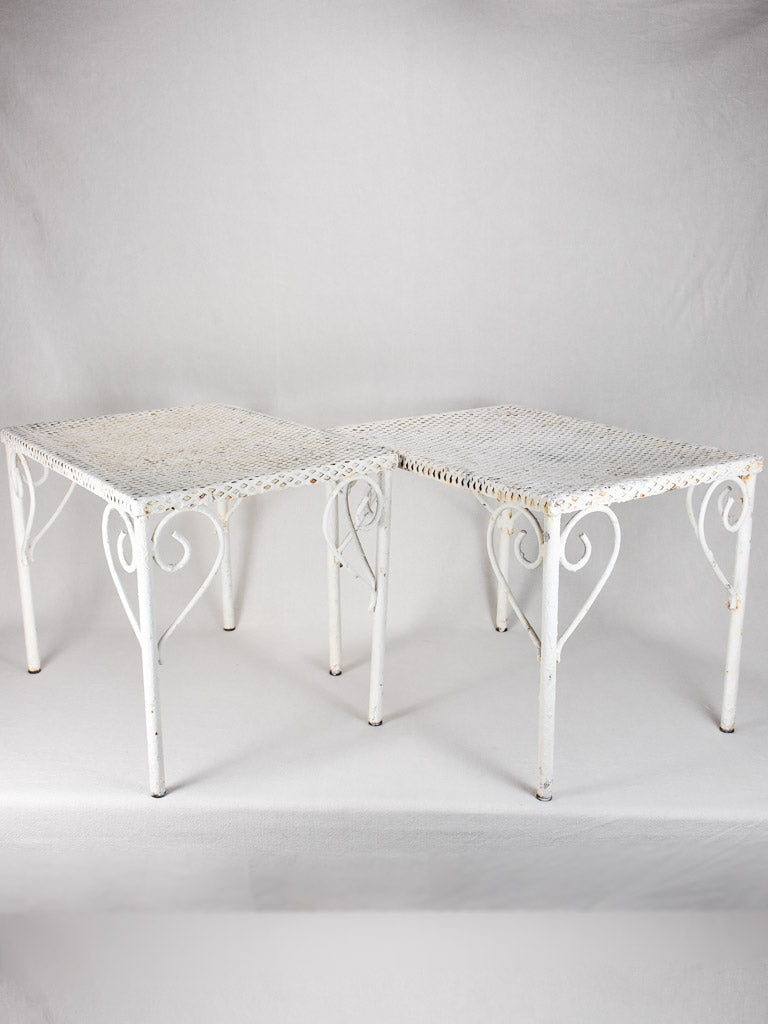 Pair of perforated wrought iron garden coffee tables