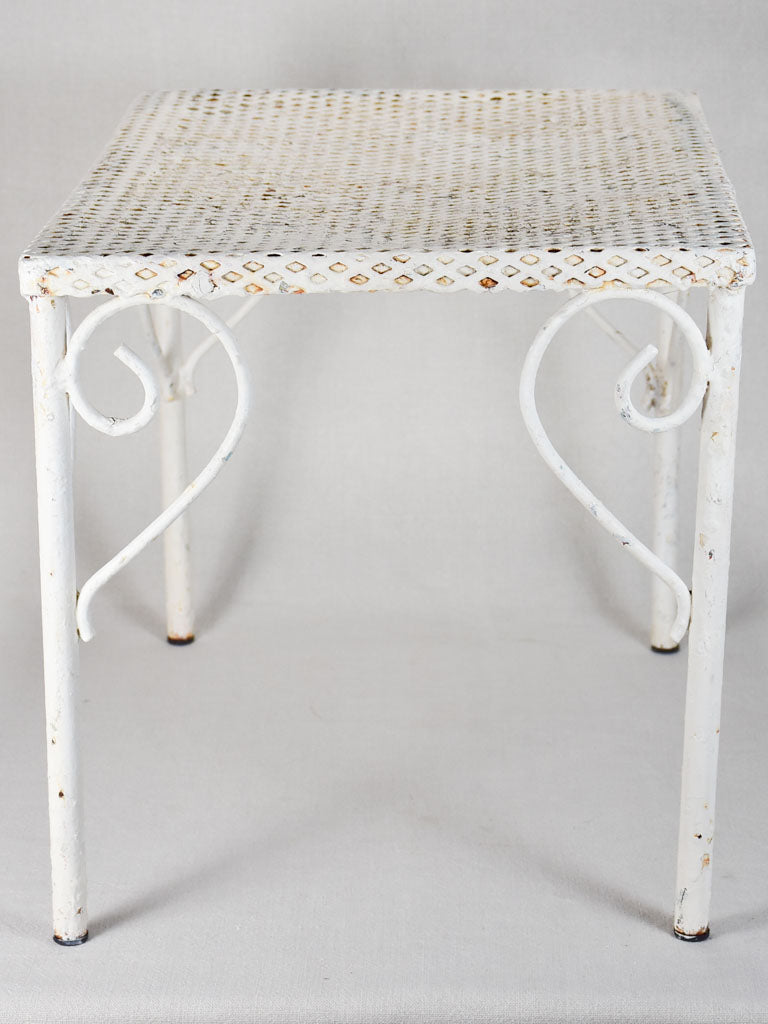 Pair of perforated wrought iron garden coffee tables