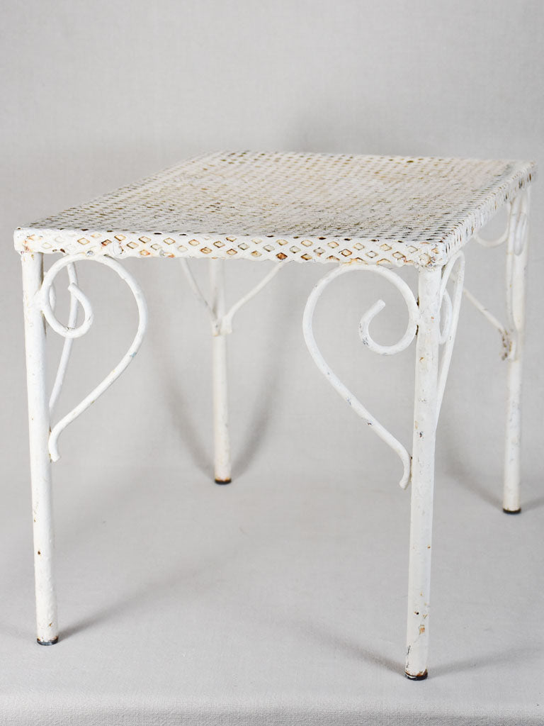 Pair of perforated wrought iron garden coffee tables