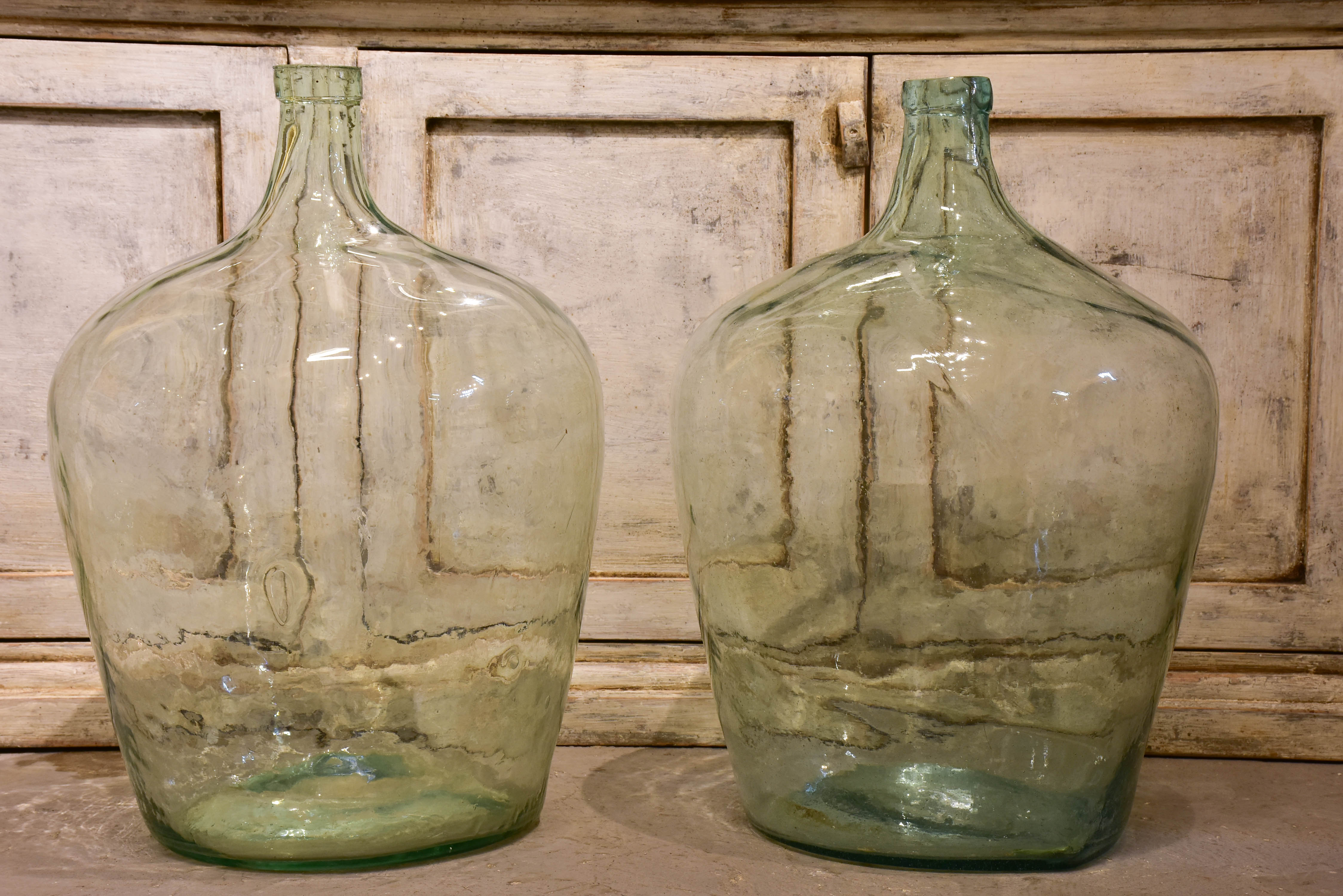 Pair of antique demijohn bottles