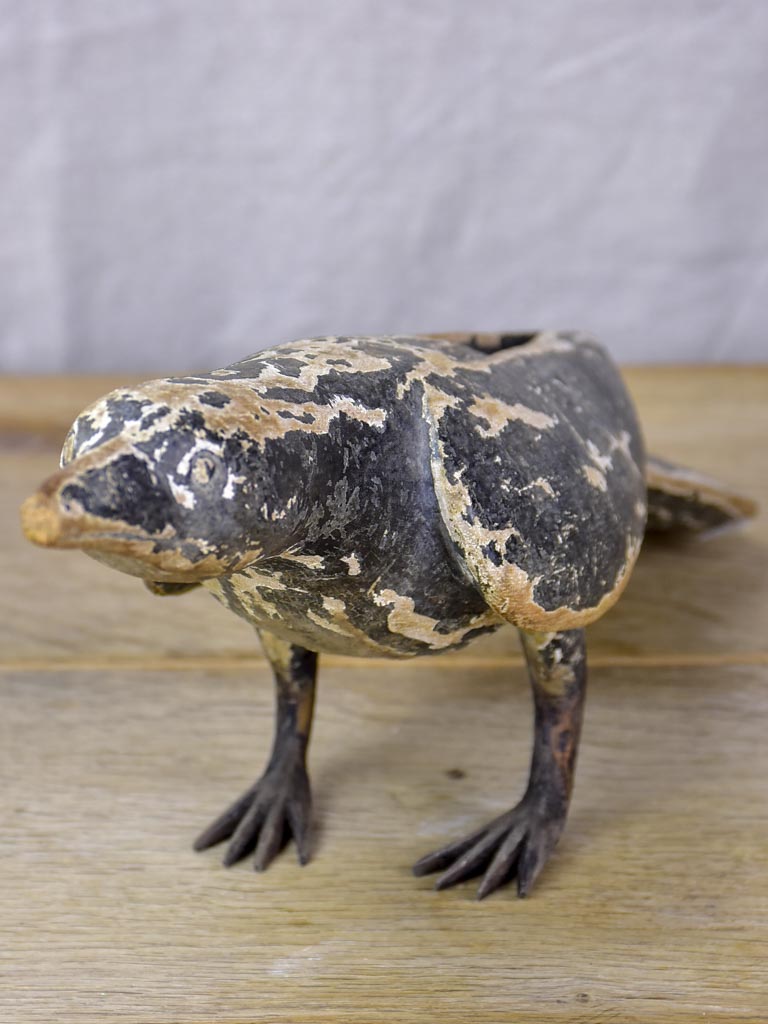 Rustic wooden sculpture of a raven - folk art