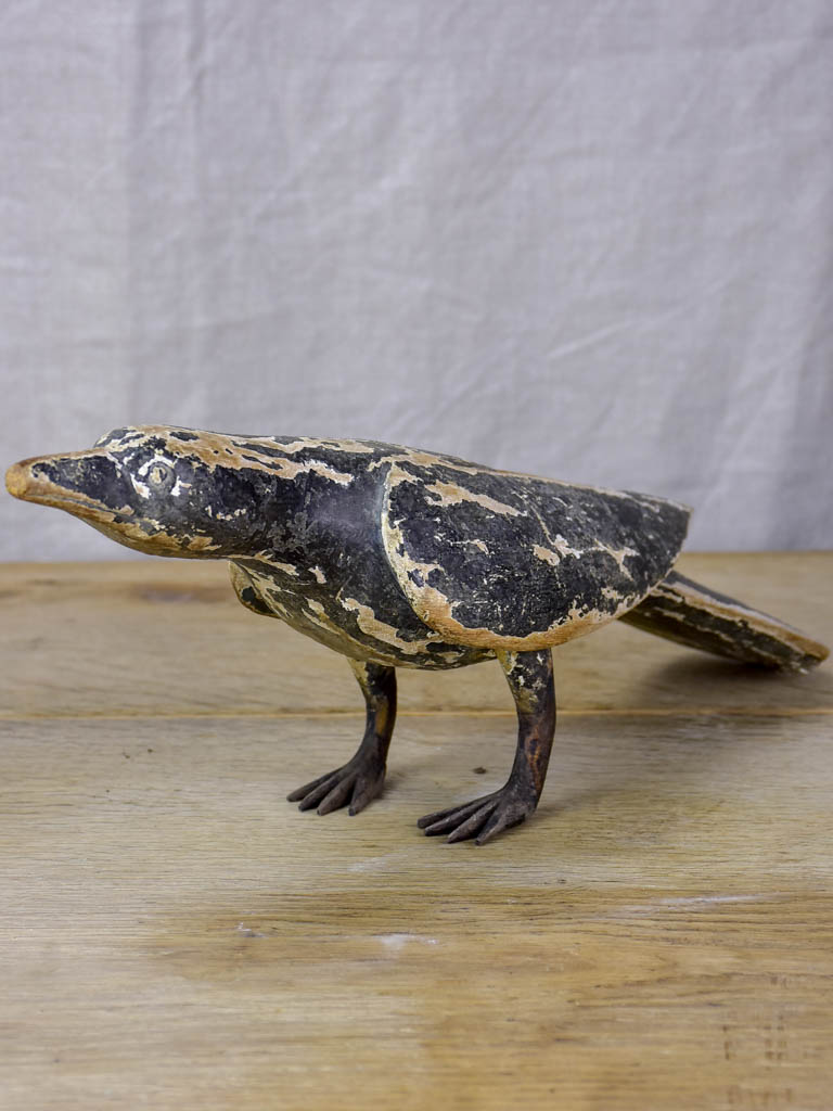 Rustic wooden sculpture of a raven - folk art