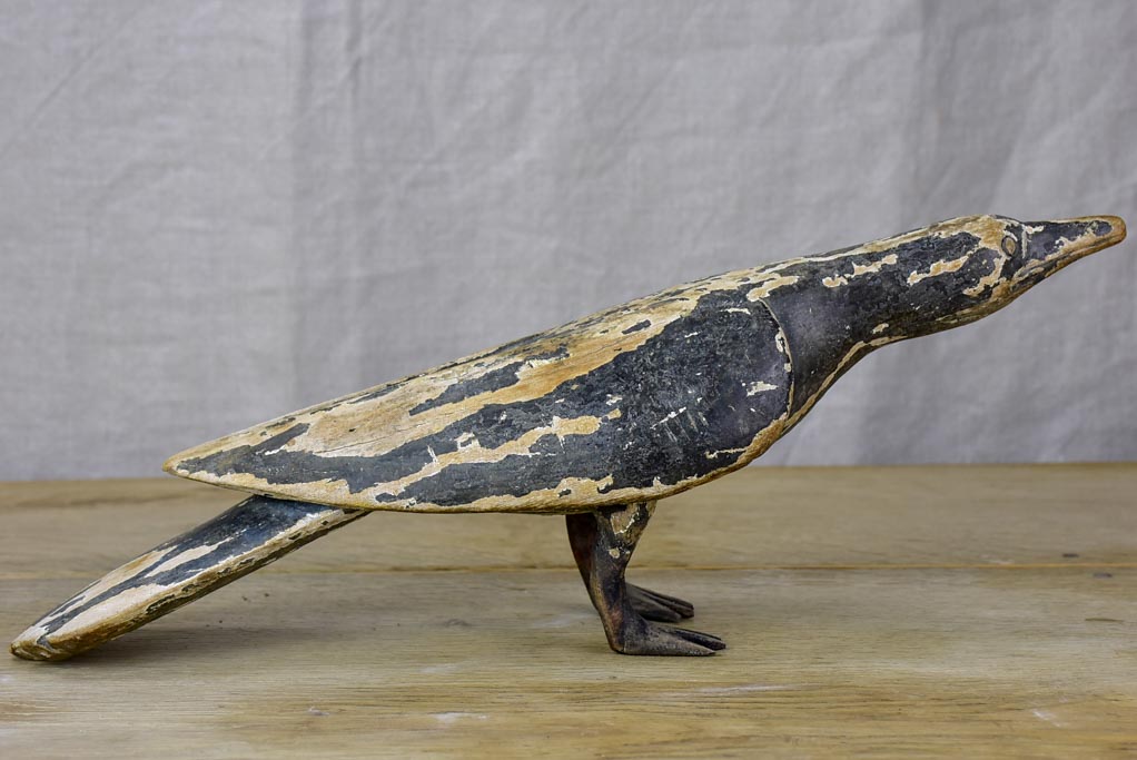 Rustic wooden sculpture of a raven - folk art