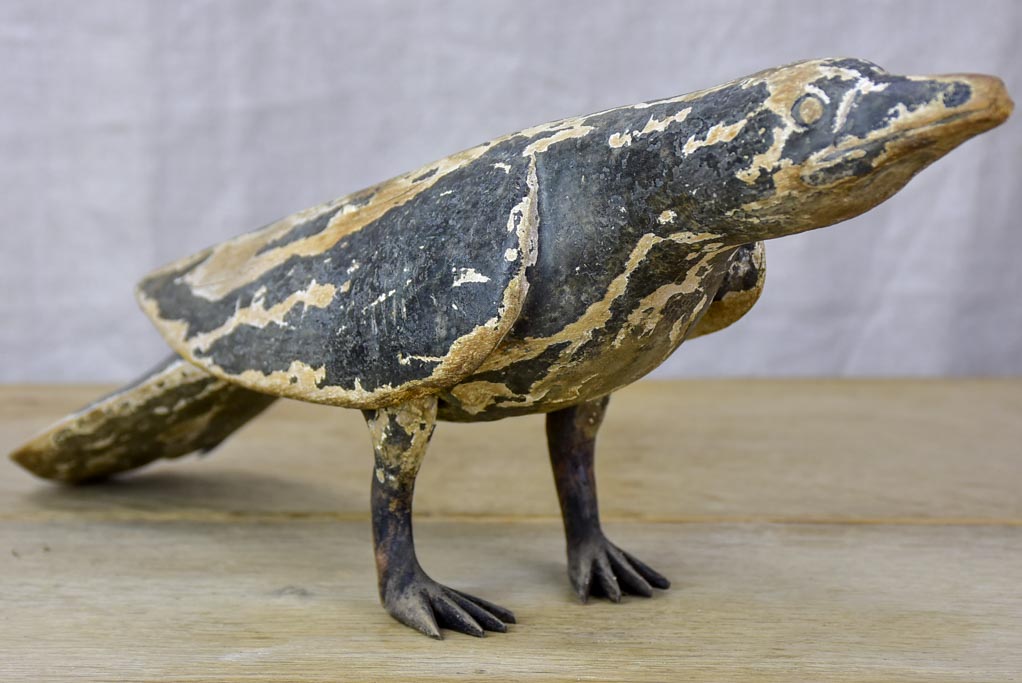 Rustic wooden sculpture of a raven - folk art
