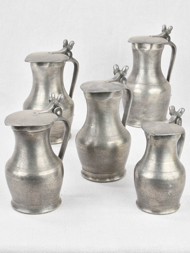 Vintage tin pitchers with ornate design