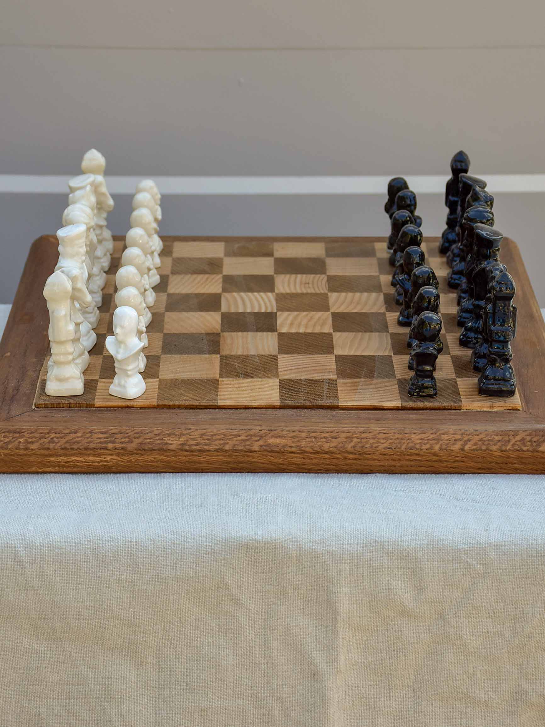 Vintage wooden chess board with porcelain pieces