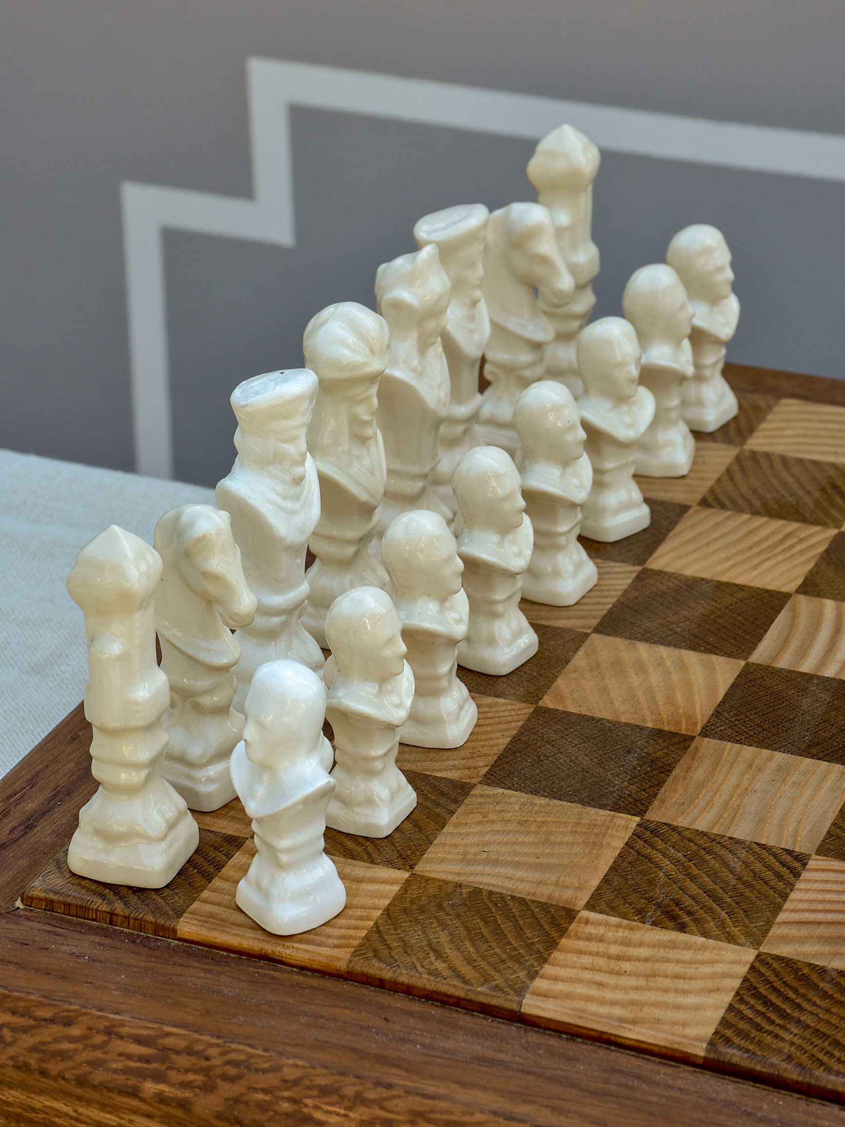 Vintage wooden chess board with porcelain pieces