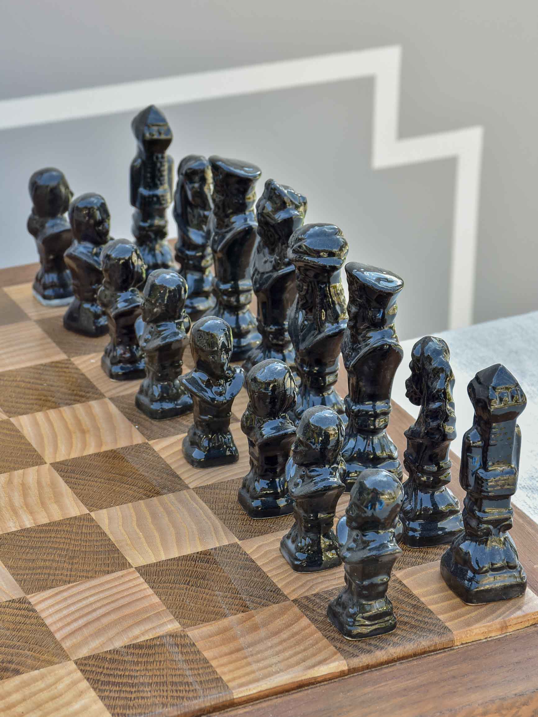 Vintage wooden chess board with porcelain pieces