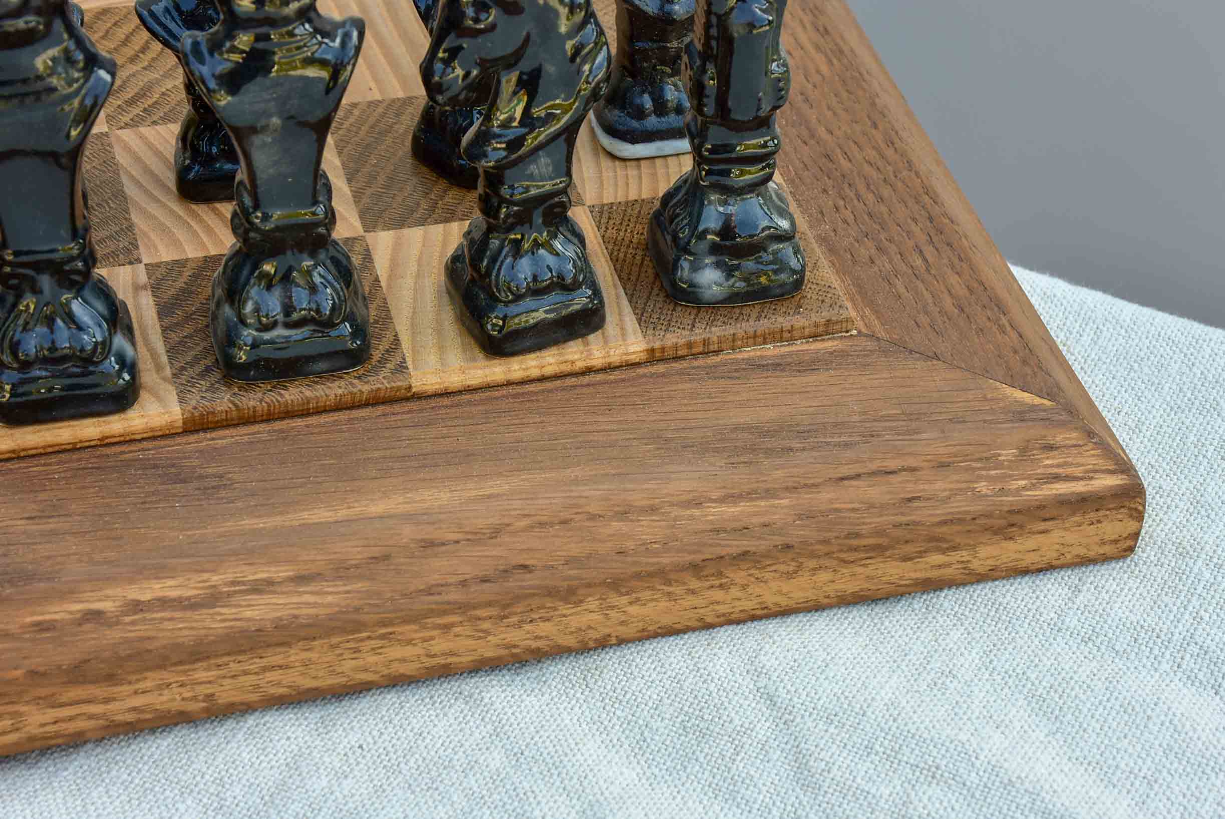 Vintage wooden chess board with porcelain pieces