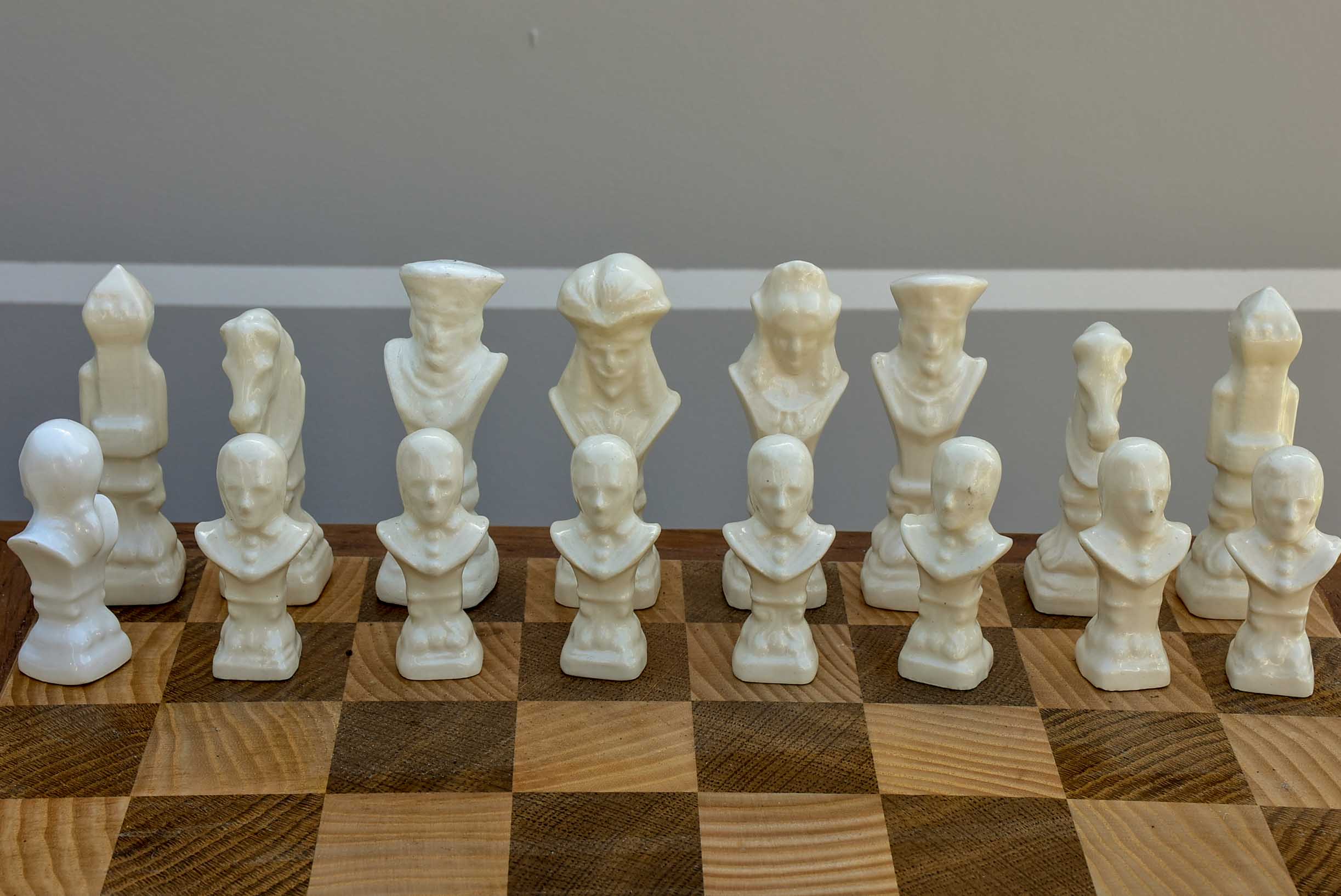 Vintage wooden chess board with porcelain pieces