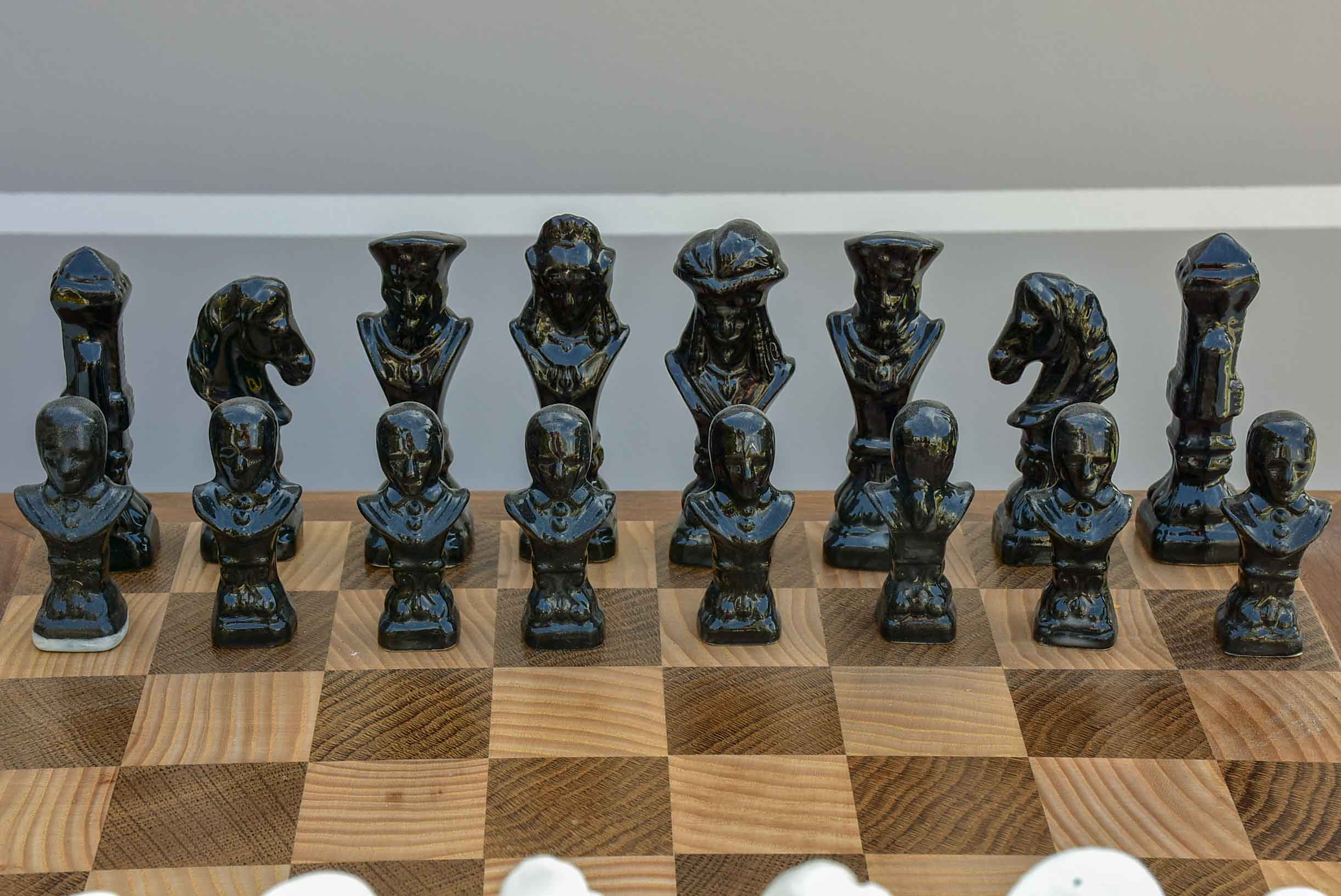 Vintage wooden chess board with porcelain pieces
