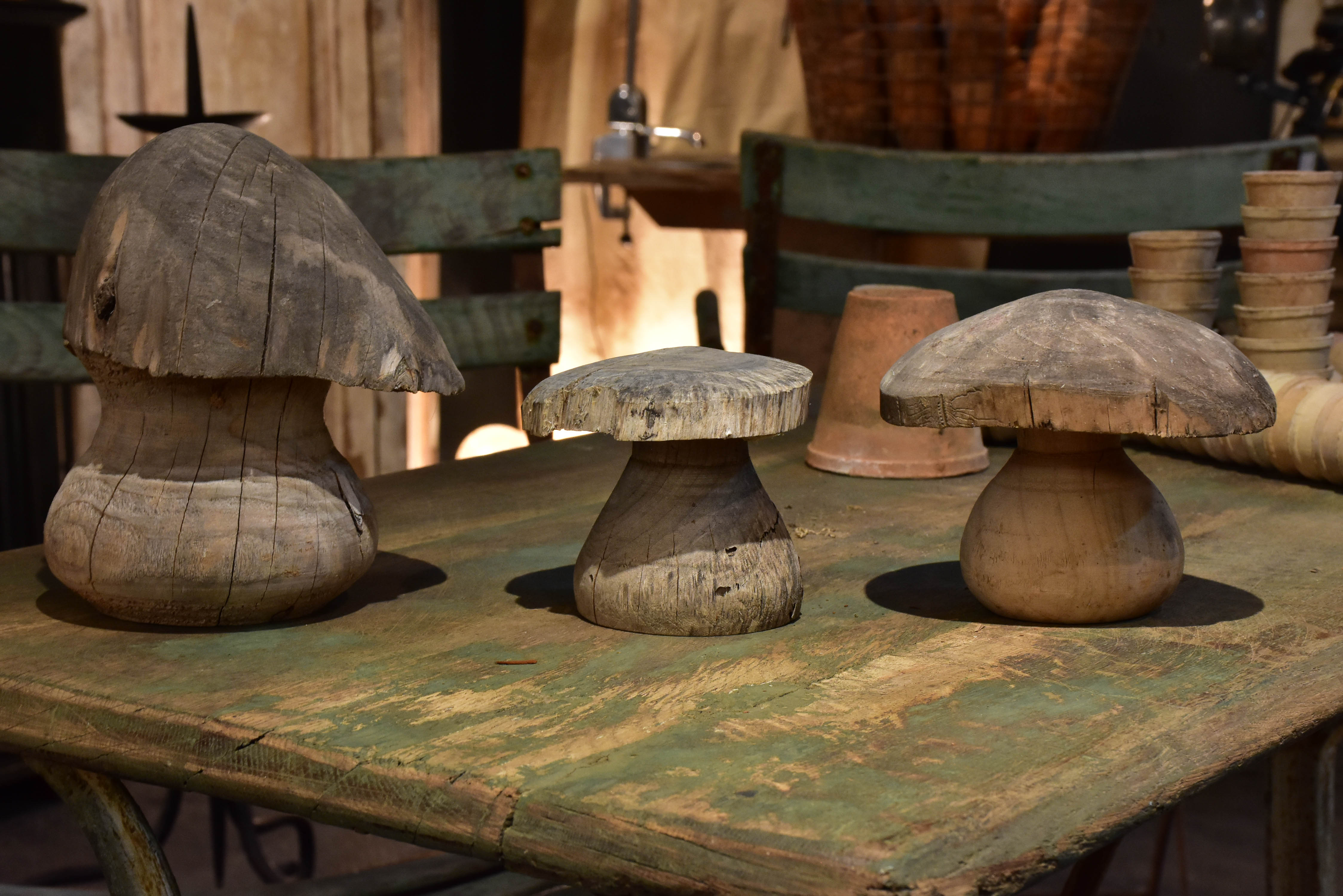 Three wooden French sculptures in the shape of mushrooms