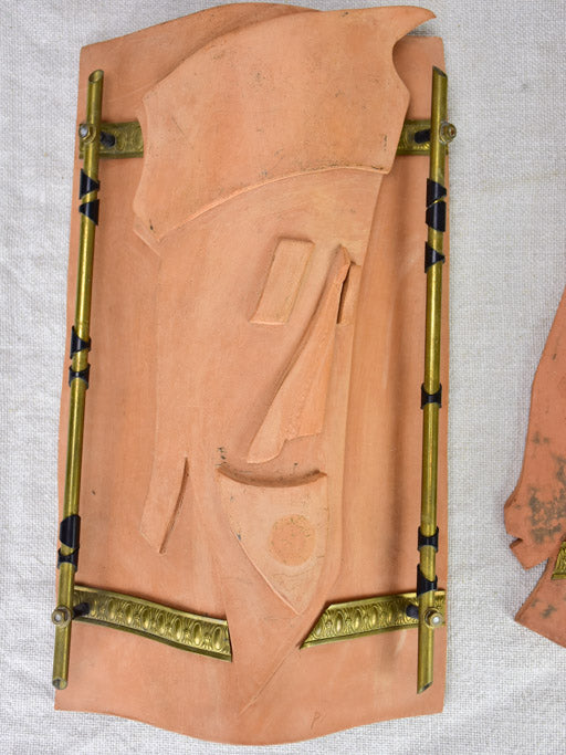 Pair of vintage handmade terracotta tile wall sconces with faces 11¾"