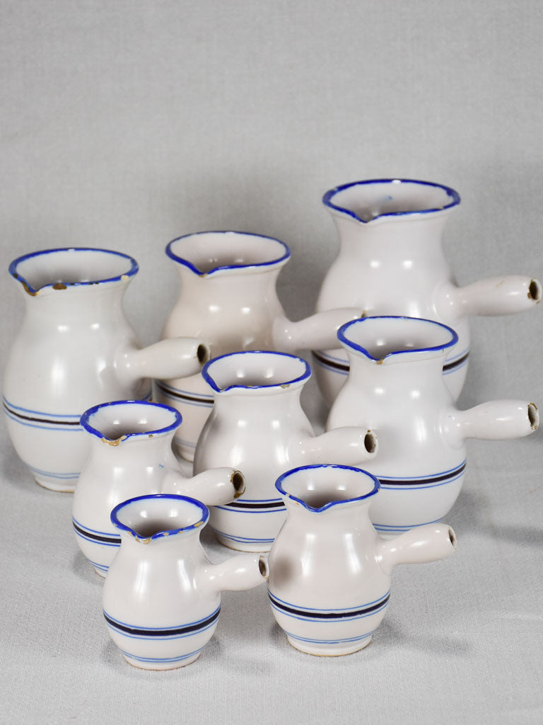 Collection of eight 19th-century white pots with blue stripes from Sète