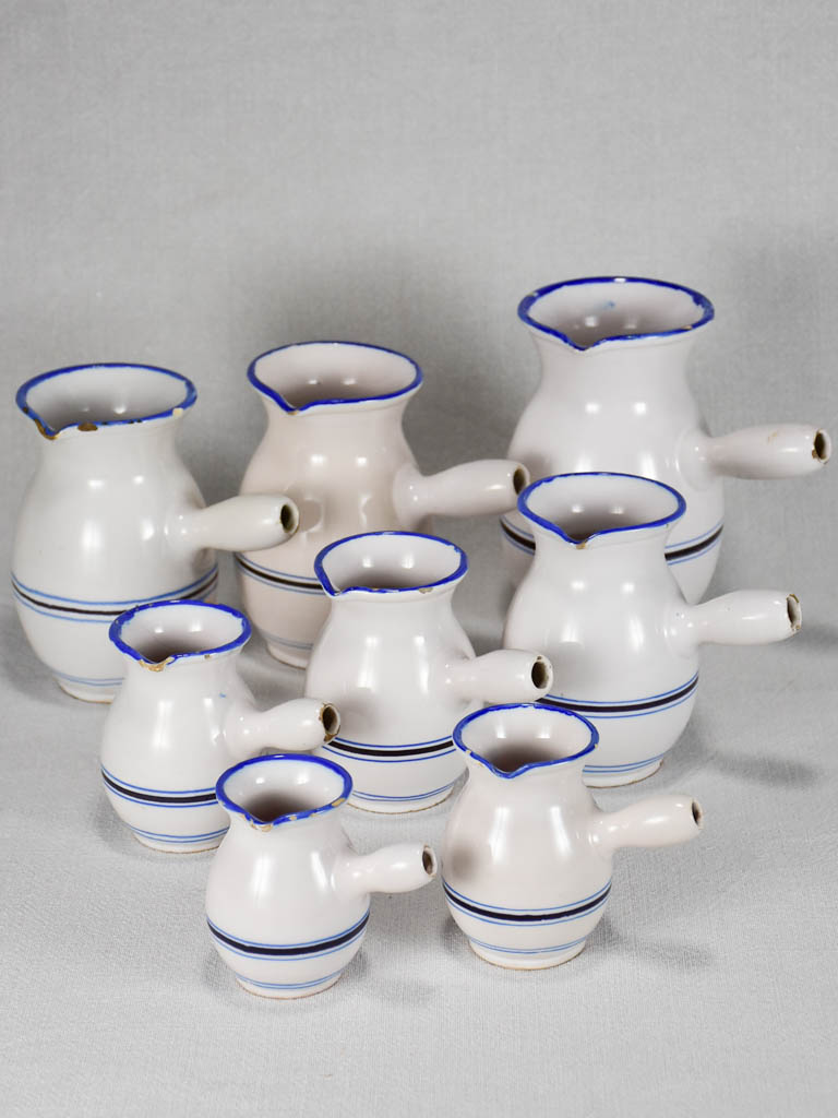 Collection of eight 19th-century white pots with blue stripes from Sète