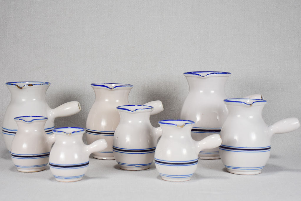 Collection of eight 19th-century white pots with blue stripes from Sète