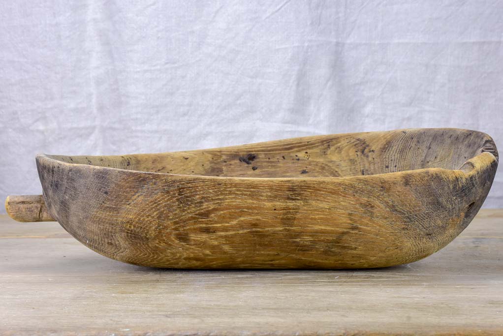 Primitive oval wooden recipient bowl with repairs 18" x 8¼"