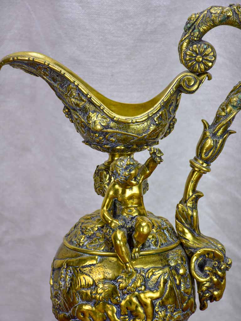 Bronze Napoleon III pitcher adorned with foliage, fruit and a cherub 17¾"