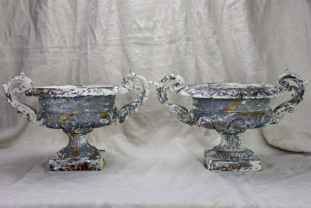 Pair of antique French Medici urns with large handles and white patina