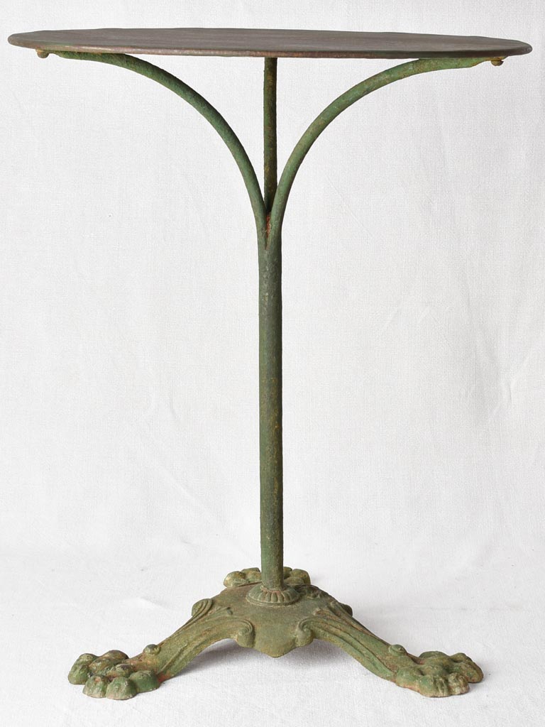 Claw foot round garden table with green patina