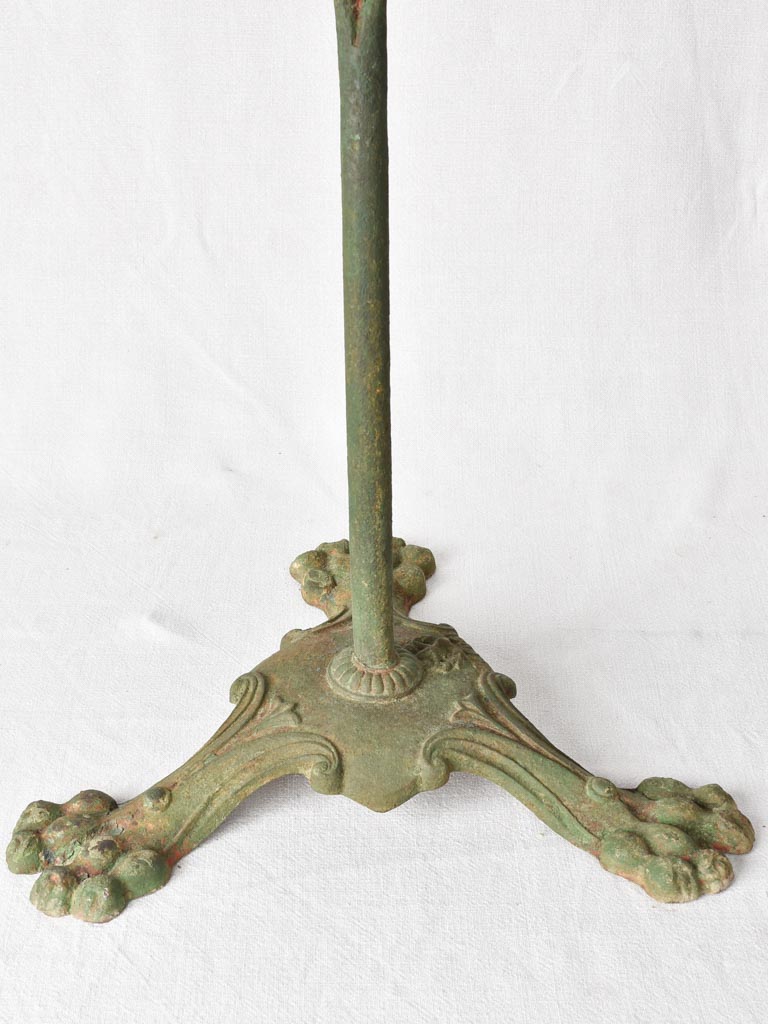 Claw foot round garden table with green patina