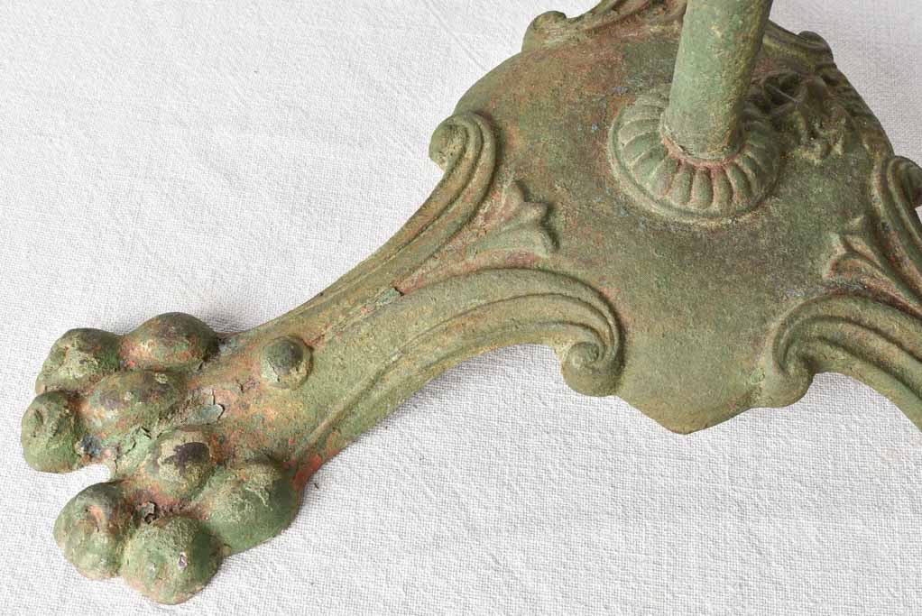 Claw foot round garden table with green patina