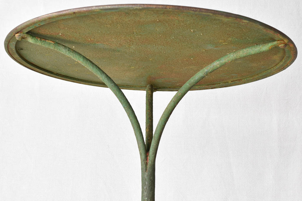 Claw foot round garden table with green patina