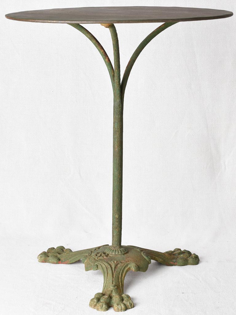 Claw foot round garden table with green patina