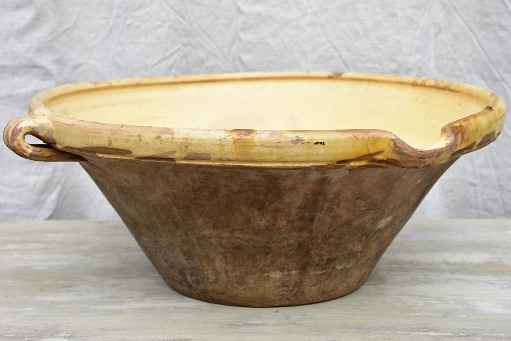 Large antique French tian bowl with yellow glaze, two handles and beak - 20¾ diameter"