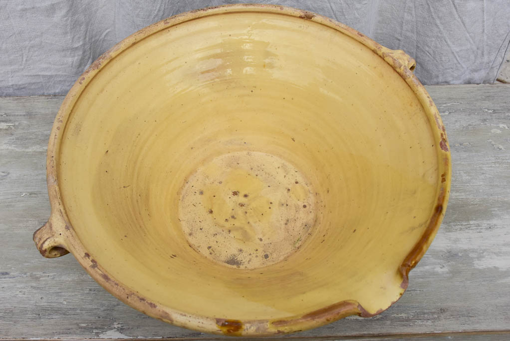 Large antique French tian bowl with yellow glaze, two handles and beak - 20¾ diameter"