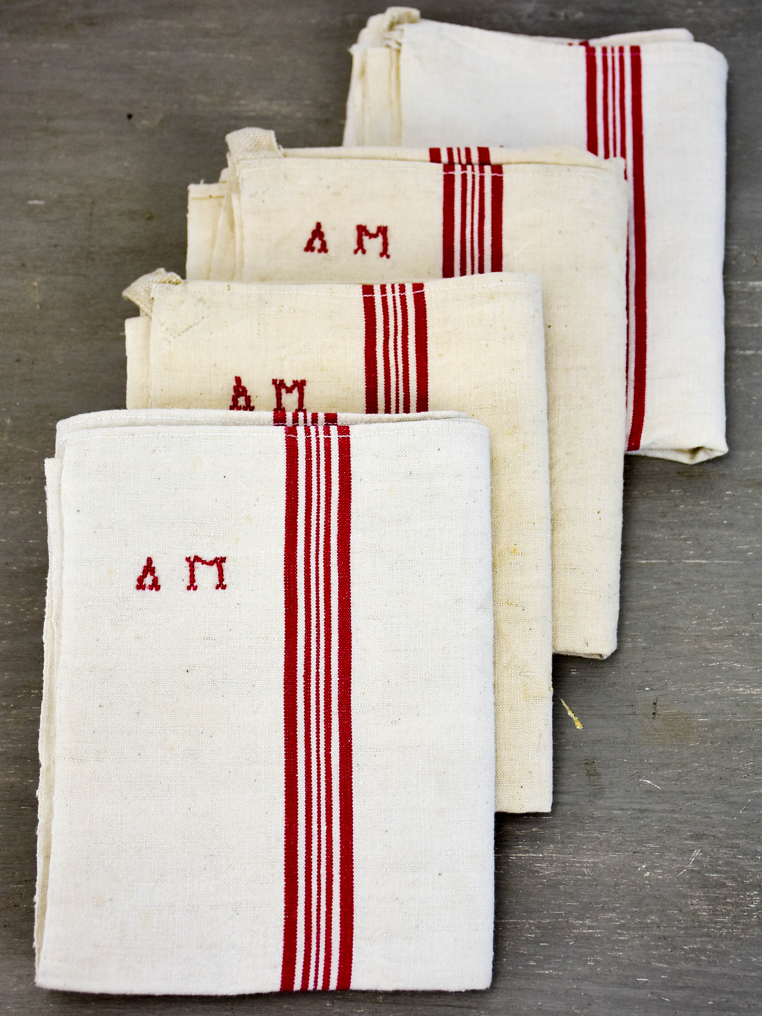 Four vintage French tea towels with AM monogram