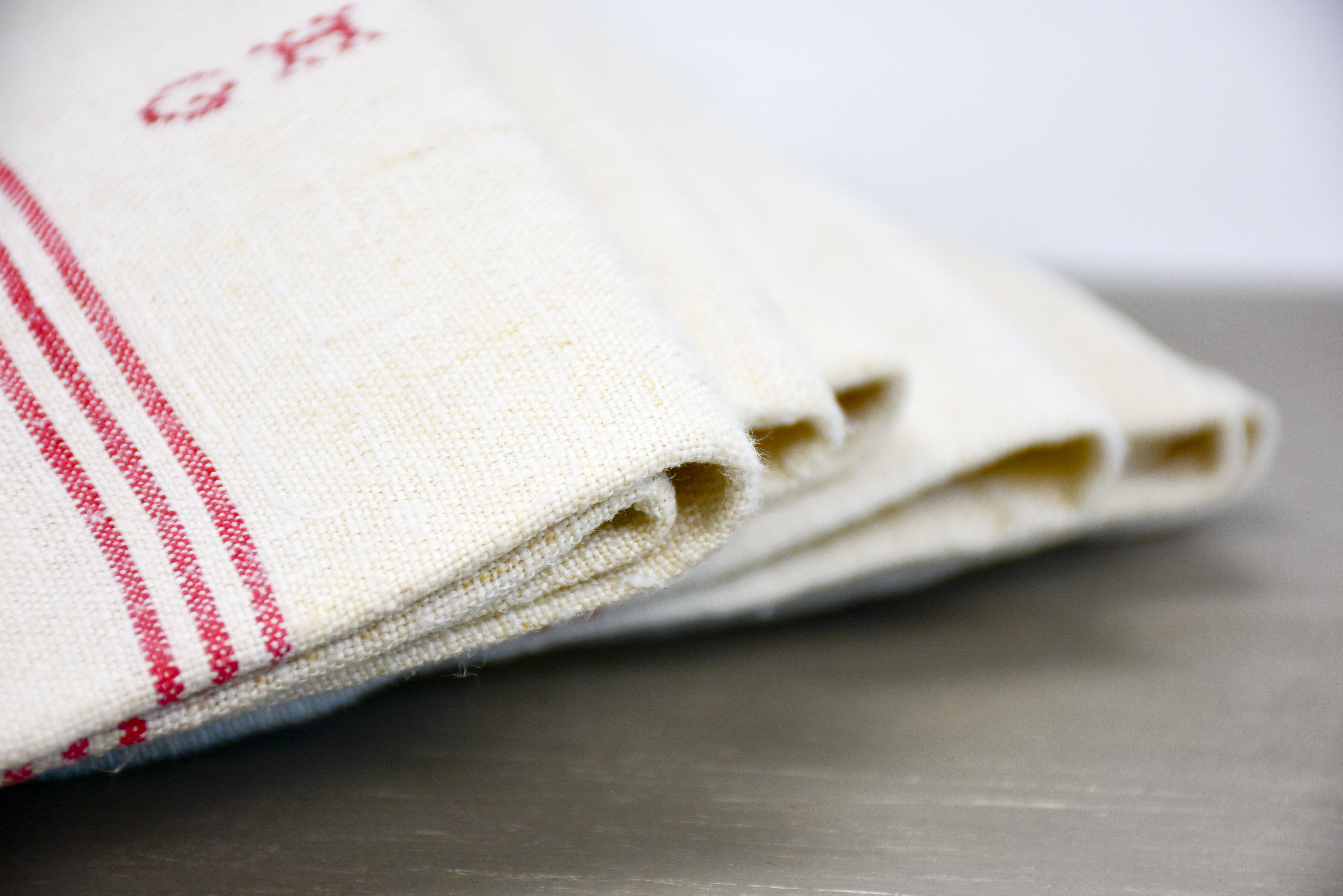 Four French tea towels with GH monogram