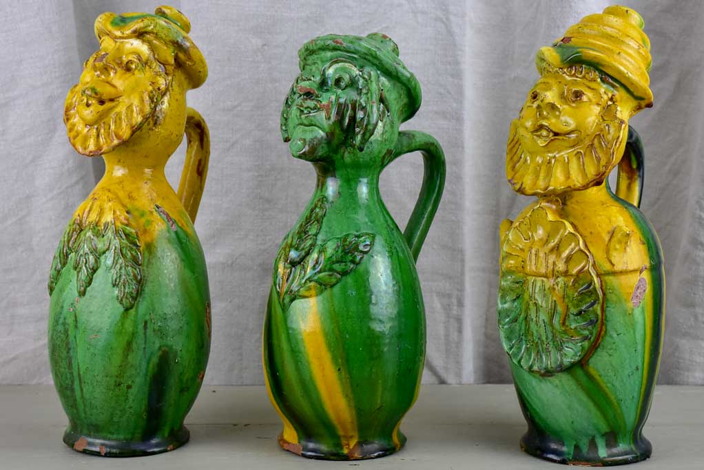 Three antique folk art pitchers with yellow and green glaze