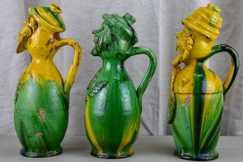 Three antique folk art pitchers with yellow and green glaze