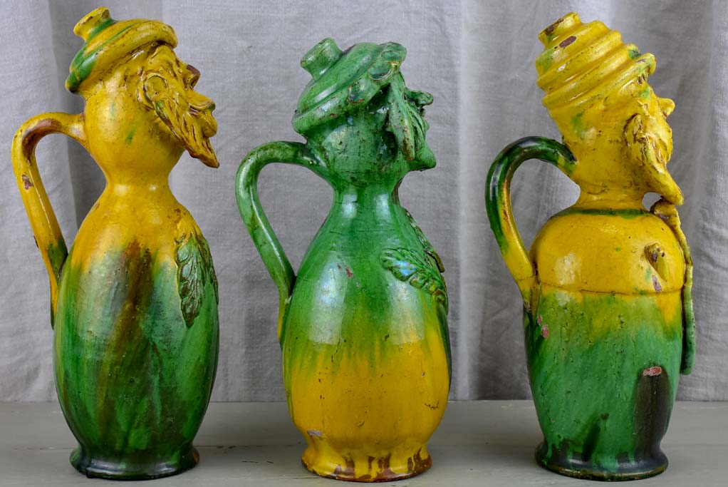 Three antique folk art pitchers with yellow and green glaze