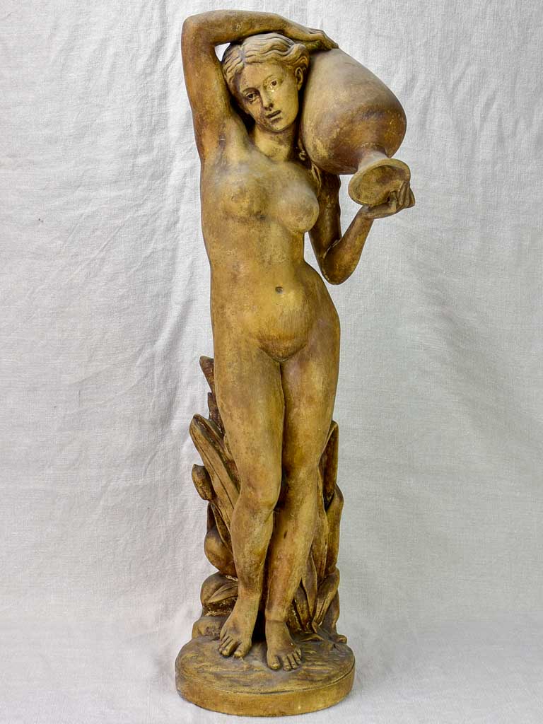 Antique terracotta sculpture of a woman holding a vase 29½"
