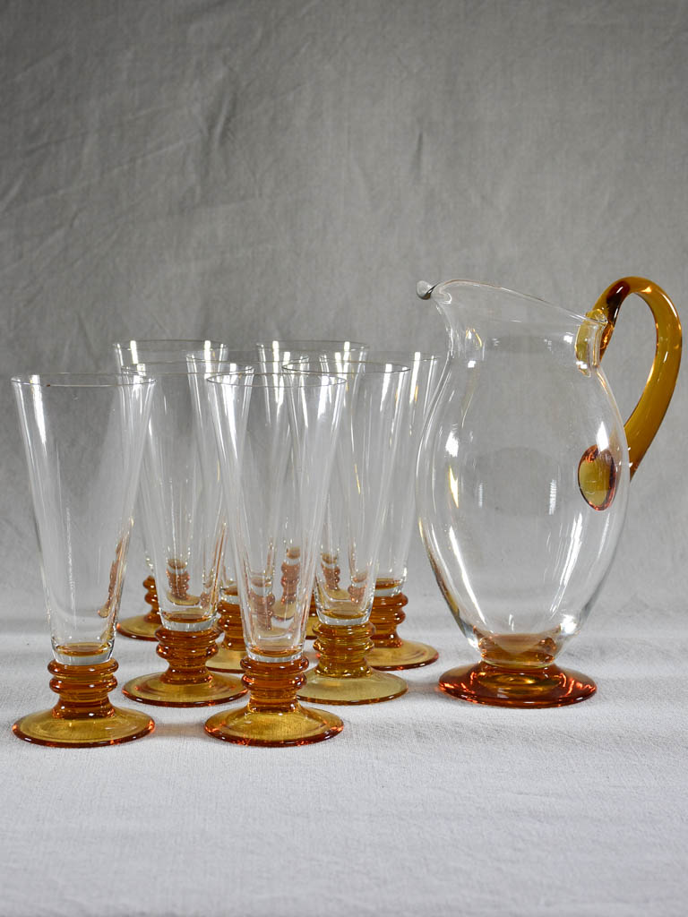 Set of eight tumblers with matching pitcher - clear and amber glass