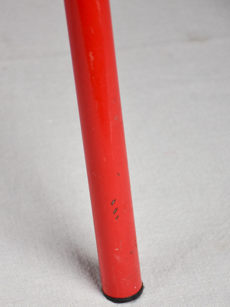 Set of ten red vintage stools from a school