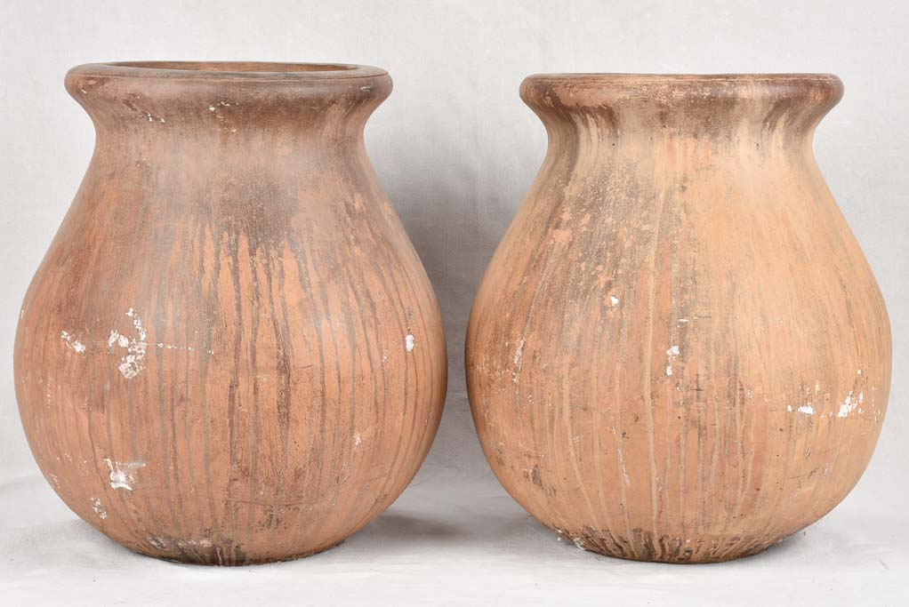 Pair of large oil jars with brown patina