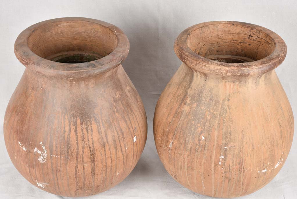 Pair of large oil jars with brown patina