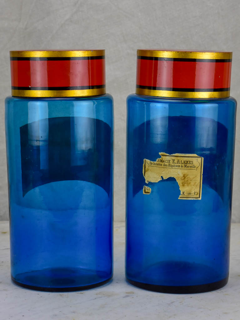 Two blue glass antique French apothecary jars with lids