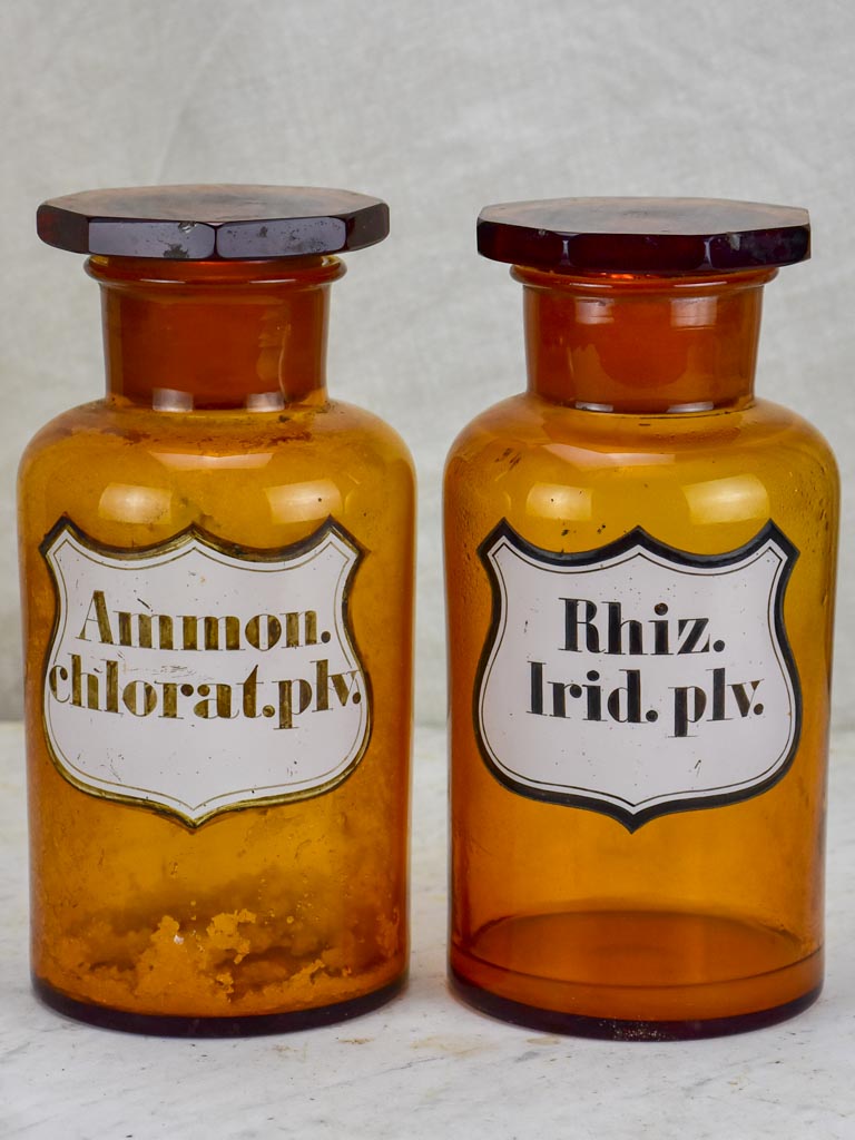 Two amber glass antique French apothecary jars with octagonal lids