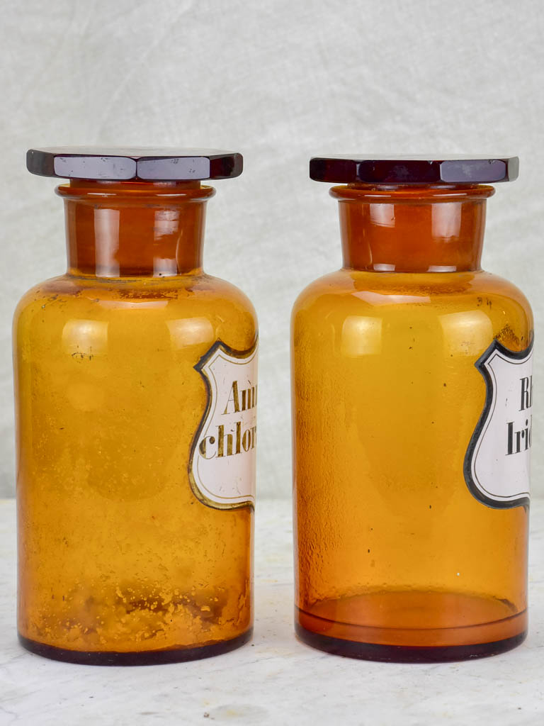 Two amber glass antique French apothecary jars with octagonal lids
