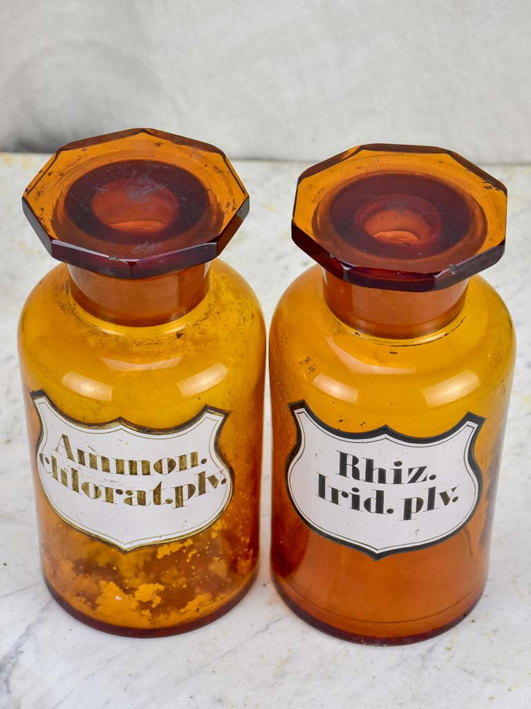 Two amber glass antique French apothecary jars with octagonal lids