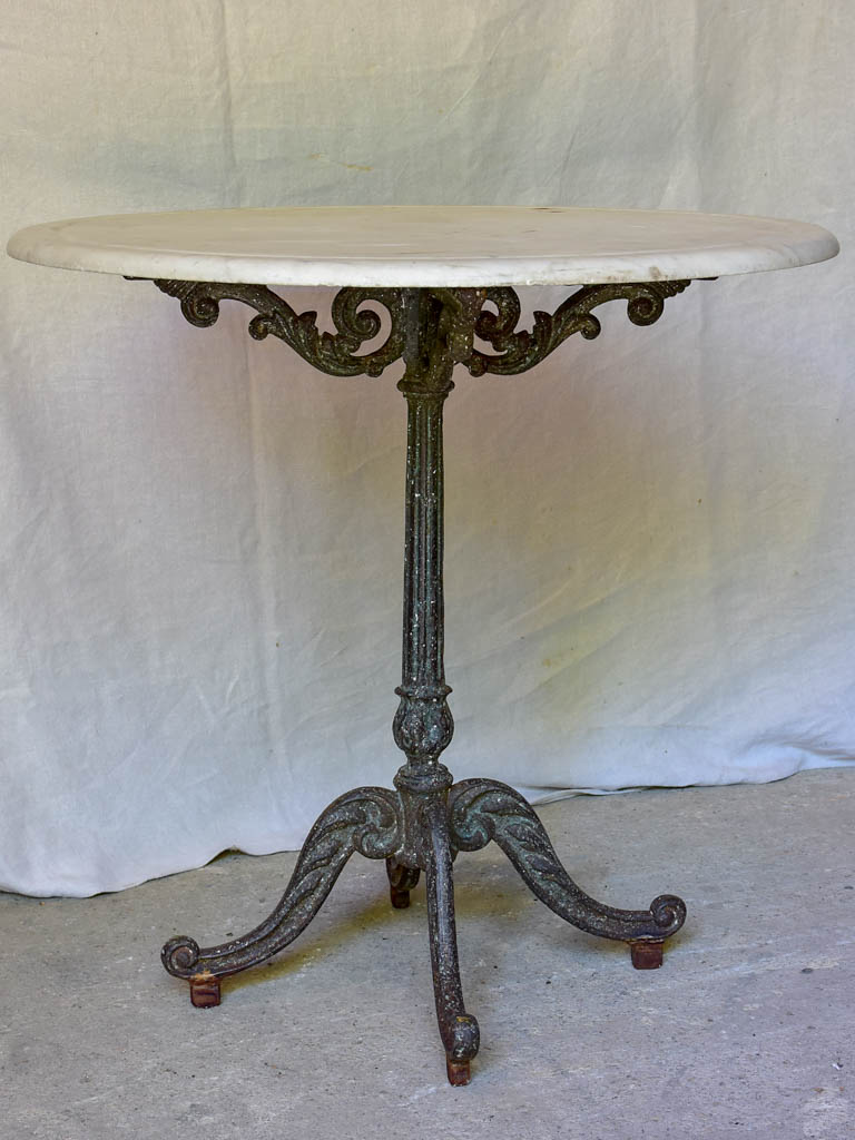 Late 19th Century round French table with marble top and cast iron base 31"